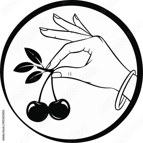 Elegant hand delicately plucks two ripe cherries from a branch with leaves
