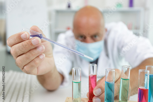 Photography a male scientist with a pipette