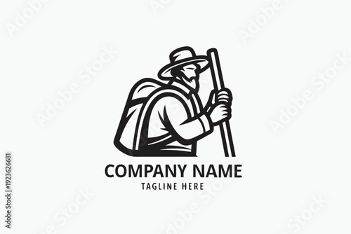 Silhouette shows a hiker with a backpack and walking stick, standing before two mountains