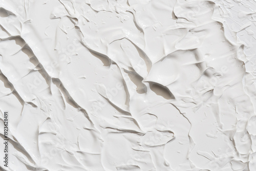 Thick white clay or cream texture with bold spatula ridges and soft shadows, abstract background for luxury skincare branding.