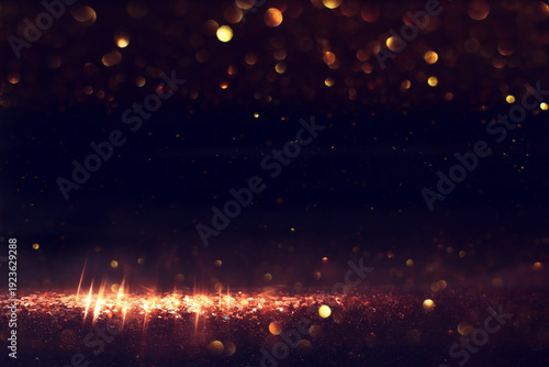 abstract glitter black and gold lights background. de-focused
