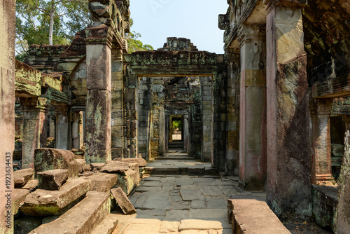Konstfotografi Sunlit passageways and weathered columns form a layered perspective through the ancient ruins of Preah Khan temple in Cambodia's Angkor region