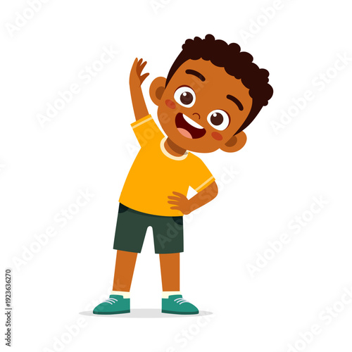 Happy African American boy stretching with a big smile wearing yellow shirt and green shorts cheerful and energetic