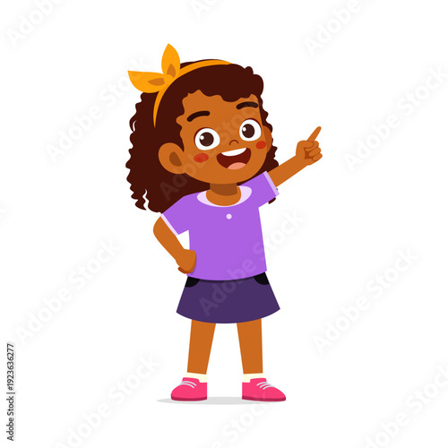 A happy smiling African American girl pointing upward with an excited expression wearing a purple shirt
