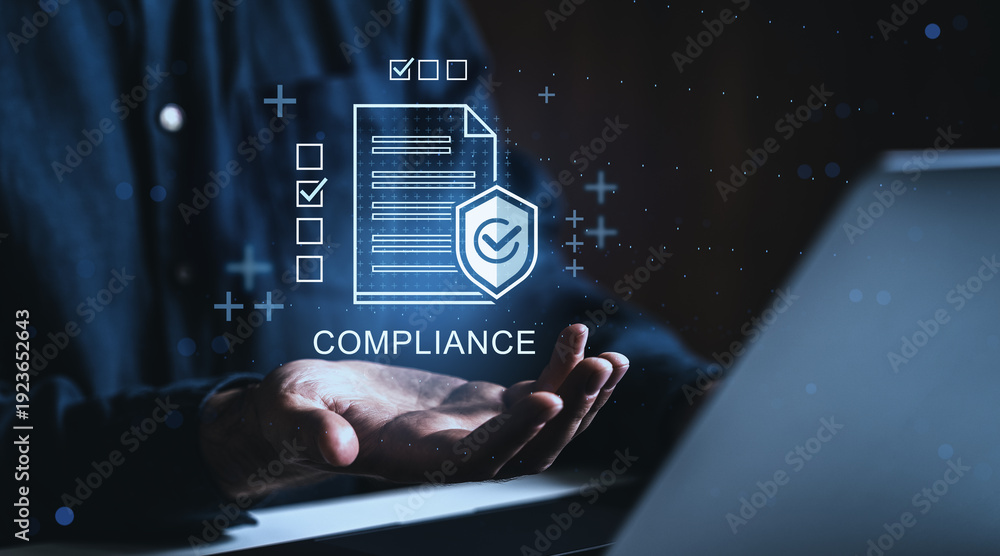 Fototapeta premium Business compliance concept with holographic checklist and shield above open hand on dark background in corporate digital environment..