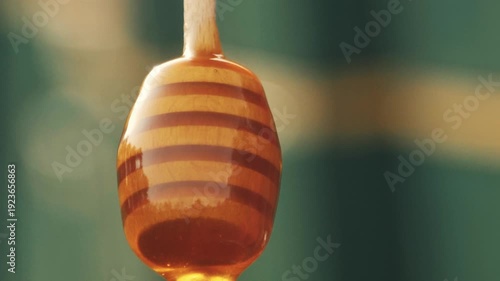 Wallpaper Mural Close-up detailed view of a beekeeper's hand stirring dark amber buckwheat honey in a glass jar at the apiary, showcasing the thick texture, Torontodigital.ca