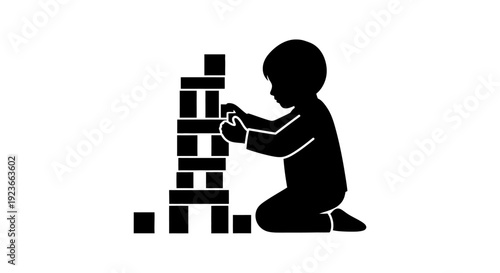 A child builds a tall tower with blocks on the floor byo