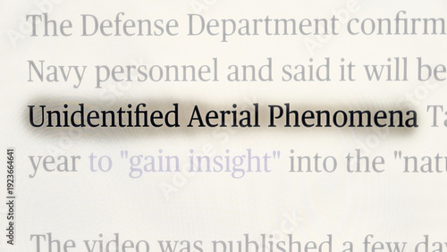 Close-up of a news headline highlighting the term “Unidentified Aerial Phenomena,” referencing official statements from the U.S. Defense Department about investigations into mysterious aerial sighting
