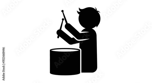 A boy enthusiastically plays a drum with sticks byo 66
