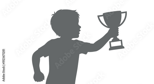 A young boy holds up a trophy in triumph.