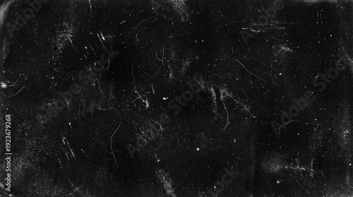 Dark textured background with scratches and white specks
