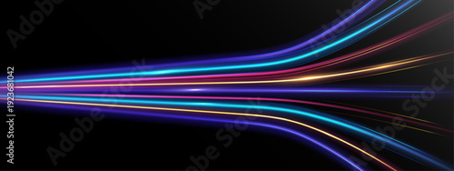 Abstract colorful neon light speed trails in motion on dark background.
