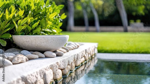 Tranquil garden scene with stone bowl and lush greenery by reflective water feature