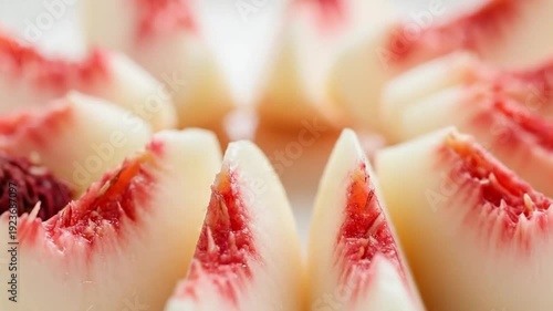 Close-up of fresh white peach slices revealing their delicate pinkish-red centers, highlighting natural sweetness and healthy fruit texture.