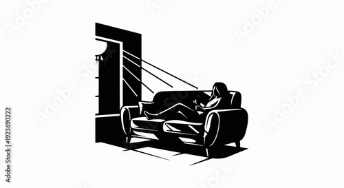 Silhouette of person relaxing on sofa, using a device
