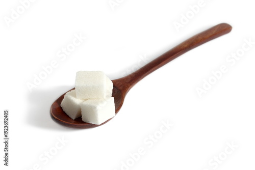 Εκτύπωση καμβά There is a wooden spoon with lump sugar on a white background.