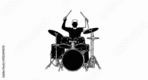 Silhouette of a drummer playing a full drum kit