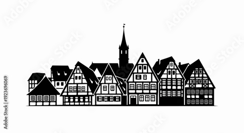 Silhouette of historic half-timbered buildings and a church steeple