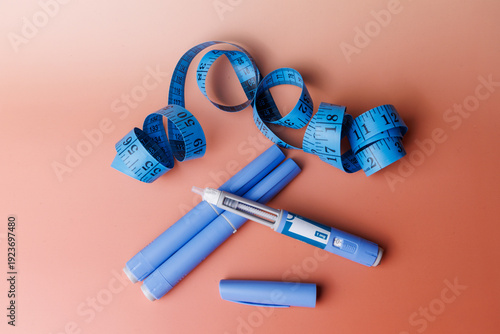 Tableau sur toile Injectable semaglutide pens for glucose control with a blue measuring tape on a clean background for weight loss and medical themes