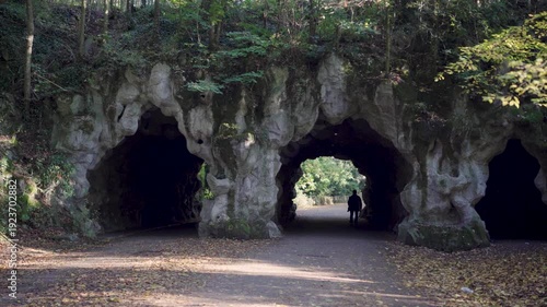Person walking through grotto tunnels in park in Ghent Belgium