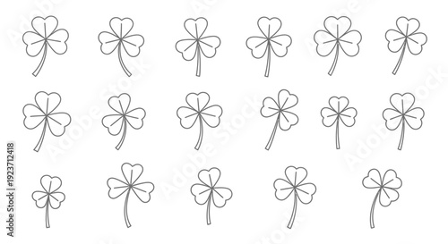 Collection of shamrocks and four-leaf clovers arranged in grid pattern, viewed from directly above