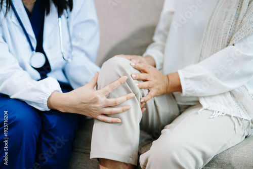Doctor examining elderly woman with knee pain during home healthcare visit, highlighting arthritis treatment, senior support, medical consultation