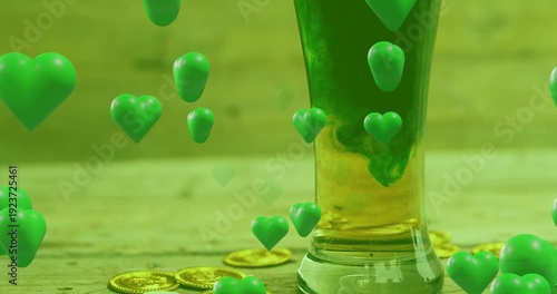 Tall narrow glass, green hearts appearing and causing dye swirling into yellow liquid for holiday