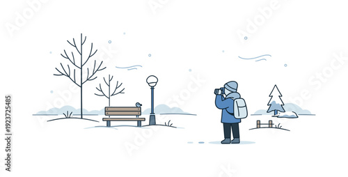 A person in winter clothes photographs a bird on a park bench in a snowy landscape