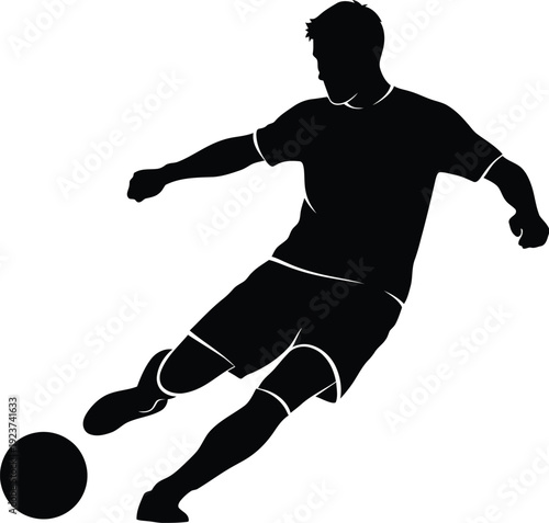 Soccer player silhouette powerfully kicking a football forward during a.