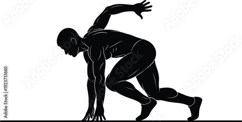 Strong male athlete crouches low in starting blocks ready for the race.