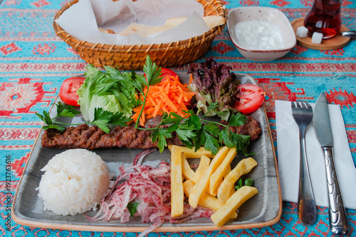 Traditional Turkish black tea and Adana kebab meal served in Istanbul restaurant