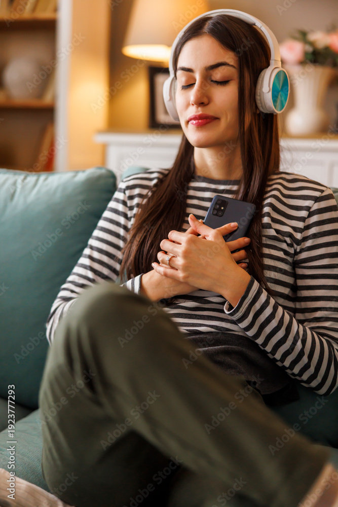 Obraz premium Woman wearing headset relaxing doing meditation session at home
