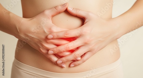 Wallpaper Mural Clinical Close-up of Lower Abdomen with Hands Pressed, Red Light Indicating Sensitivity and Care Torontodigital.ca