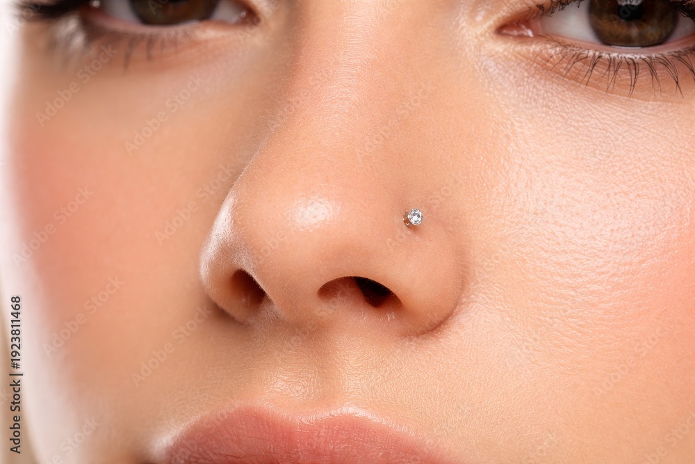 Fototapeta premium Woman with a diamond nose ring close-up shot. Body piercing fashion accessory. Facial jewelry for style and expression.