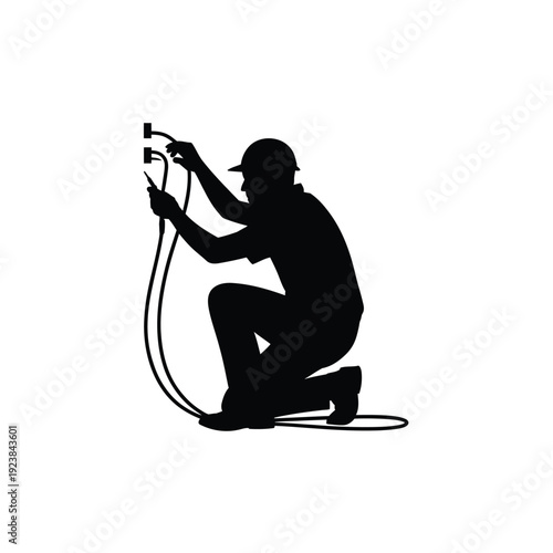 Silhouette of a person working with a hose and a fire hydrant