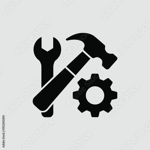 Black and white of a wrench hammer and gear