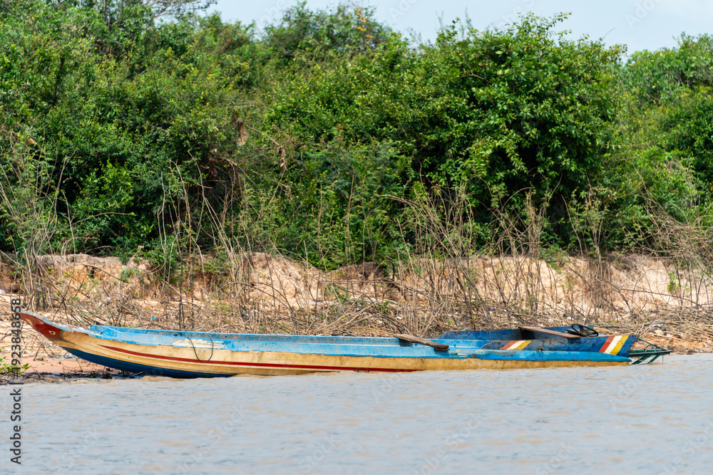 Fototapeta premium Traditional wooden fishing boat at the bank of the Siem Reap River, Cambodia.