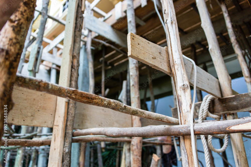 Naklejka premium Bamboo and wooden scaffolding at a building site, Cambodia