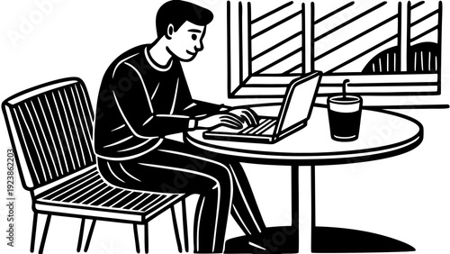 A focused individual working diligently at a desk with a computer and papers.