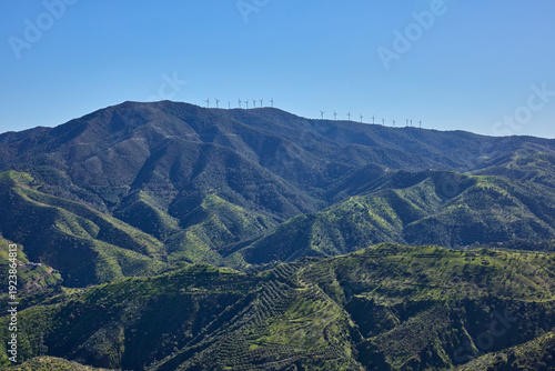 Wind turbines generating clean energy on mountain ridge