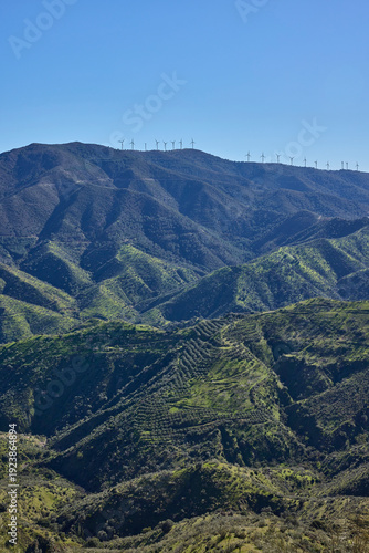 Wind turbines generating clean energy on mountain ridge