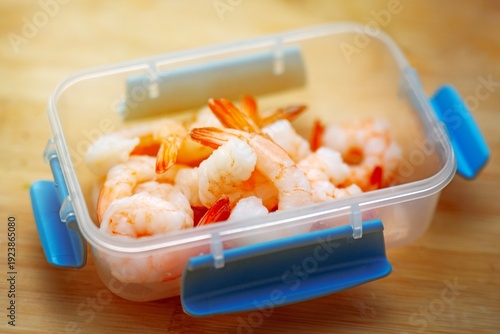 Wallpaper Mural Small food container with boiled peeled shrimp on a wooden table for work or study lunch. Healthy seafood meal prep. Torontodigital.ca