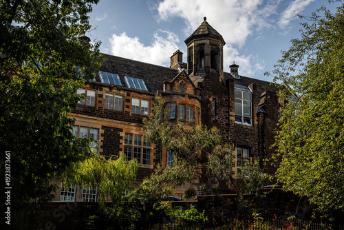 Historic stone building with skylights and turrets in a Scottish city