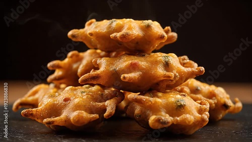 Golden Brown Deep Fried Pakora Stack Appetizer Snack Served Hot on Dark Slate Background With Subtle Steam Rising
