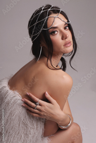 beautiful sexy slavic woman with dark hair in luxurious outfit with jewelry