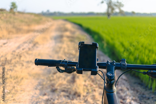 Photos Smartphone Navigation on Bicycle in Countryside Road Travel Concept