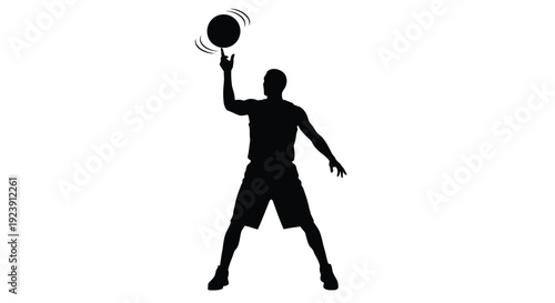 A basketball player dribbling captured in a striking black silhouette
