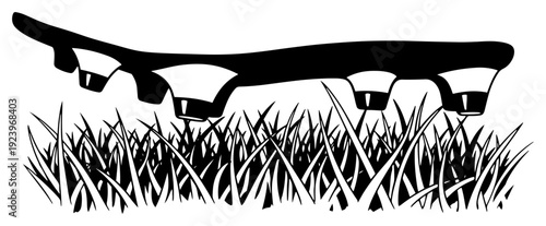 Close up view of soccer cleat studs on grass field in black and white