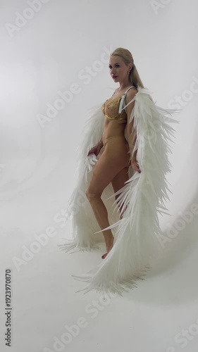 Glamorous Angel Model Posing in a White Studio