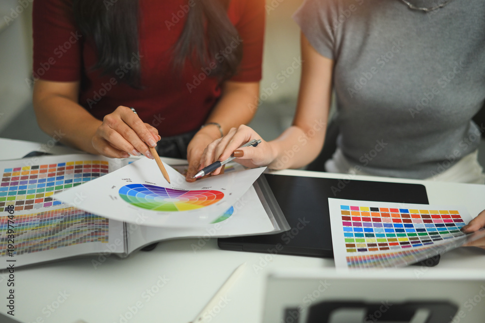 Fototapeta premium Graphic designer with colleague brainstorming on table